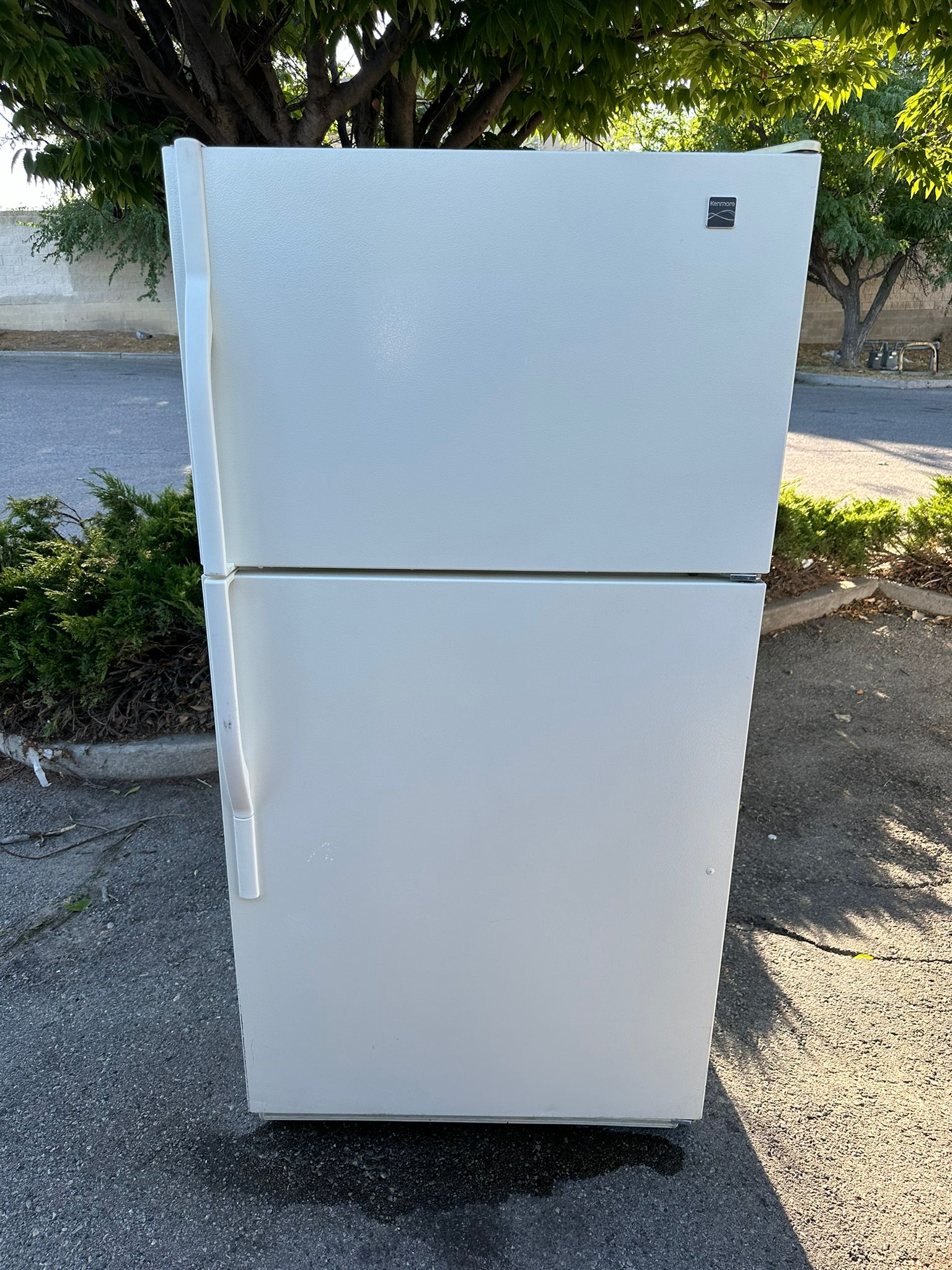 White Kenmore top-freezer refrigerator photographed outdoors, illustrating San Diego appliance pickup requests
